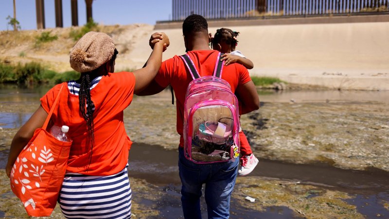 A file photo shows an asylum-seeking migrant family from Haiti cross the Rio Bravo to turn themselves in to U.S Border Patrol agents to request asylum in El Paso, Texas, as seen from Ciudad Juarez, Mexico, April 22, 2022. (OSV News photo/Jose Luis Gonzalez, Reuters)