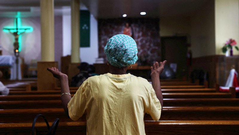 A woman prays during a Creole-language Mass at St. Jerome Catholic Church in the Little Haiti neighborhood of Brooklyn, N.Y., July 28, 2026, as the area braces for possible immigration enforcement actions on Temporary Protected Status for Haitians. The U.S. Supreme Court ruled June 25 the Trump administration can end TPS shielding eligible Haitian and Syrian immigrants living in the U.S. from deportation. (OSV News photo/Shannon Stapleton, Reuters)