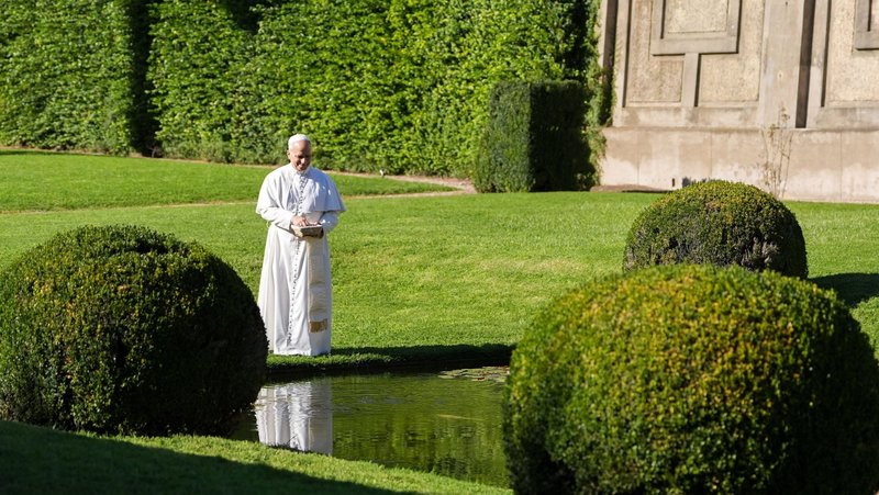 Pope Leo XIV feeds fish at a pond in the Pontifical Gardens of Castel Gandolfo, Italy, Sept. 5, 2025. (CNS photo/Lola Gomez)