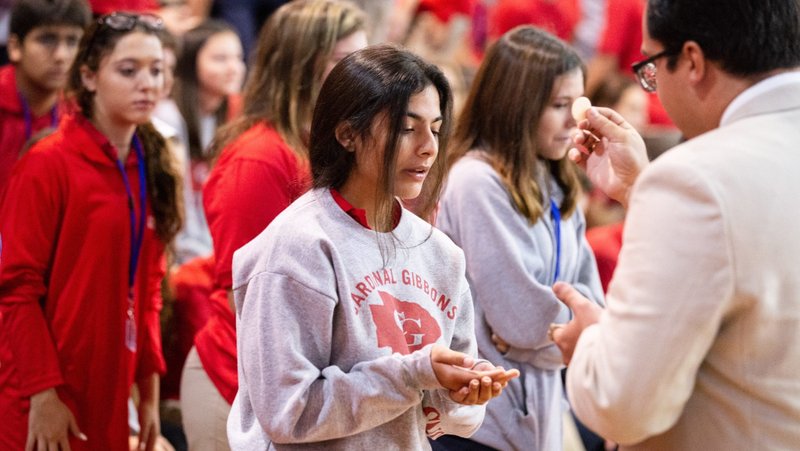 A file photo shows students at Cardinal Gibbons High School in Fort Lauderdale, Fla., receiving Communion during a Mass and rally for the opening of the school year. Florida Attorney General James Uthmeier sent a letter July 31, 2026, to the Catholic bishops of Florida demanding that Catholic schools in the Sunshine State adopt religious exemptions to vaccine requirements or risk their ability to participate in the state's school voucher program. (OSV News photo/Tom Tracy)