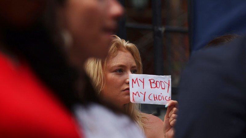 A demonstrator holds a sign outside the Massachusetts Statehouse in Boston June 24, 2022, after the U.S. Supreme Court overturned Roe v. Wade in its Dobbs ruling. On Aug. 10, 2026, Massachusetts Gov. Maura Healey signed a bill into law that eliminates prior legal restrictions on abortion after 24 weeks of pregnancy. (OSV News photo/Brian Snyder, Reuters)