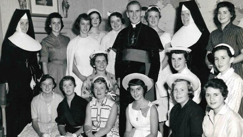 Archbishop Fulton J. Sheen is seen in an undated photo posing with women who worked at the Society for the Propagation of the Faith in New York City. (OSV News photo/Pontifical Mission Societies USA Archives)