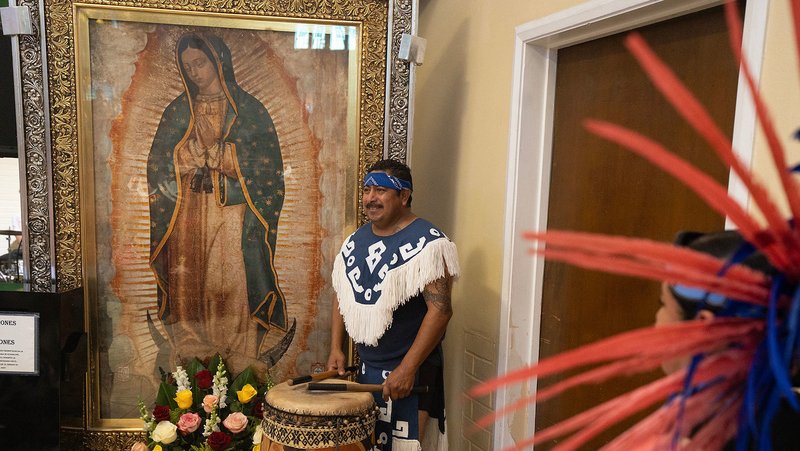 Aztec dancers perform in front of the pilgrim image of Our Lady of Guadalupe at St. Marcellinus Church in Commerce to kick off the annual tour of the Archdiocese of Los Angeles. (Poncho Romero)