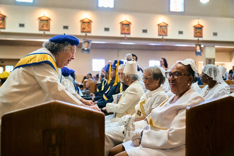 Attendees greet each other during the Aug. 14 funeral Mass for Deacon Hosea Alexander at Holy Name of Jesus Church in Los Angeles. (John Geronilla)