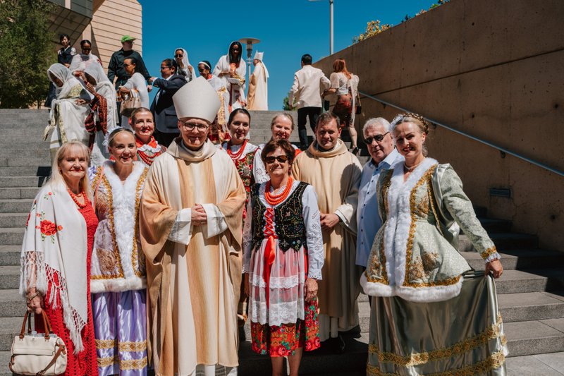 Auxiliary Bishop Slawomir Szkredk poses with the faithful who attended the "One Mother, Many Peoples" Mass at the Cathedral of Our Lady of the Angels on Sept. 5. (Peter Lobato)