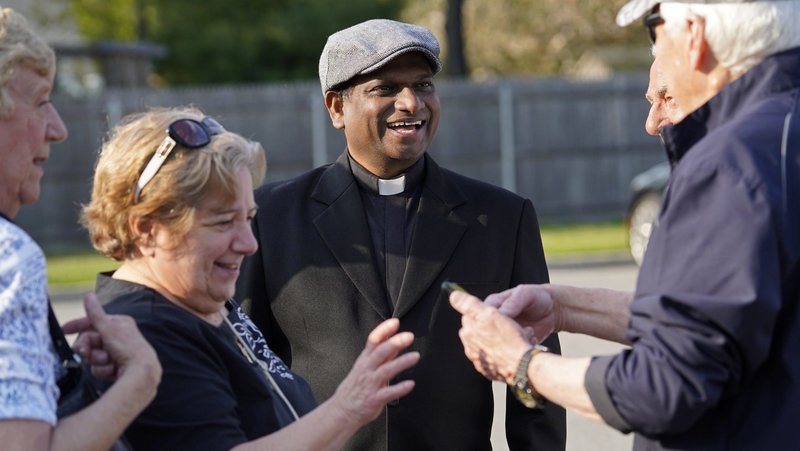 Father Charles Gnanapragasam chats with well-wishers following a "Keep Our Priests" rosary rally at St. Mary Church in East Islip, N.Y., April 29, 2024. More than 300 people gathered to pray for changes in U.S. immigration procedures to prioritize visa and Father Charles Gnanapragasam chats with well-wishers following a “Keep Our Priests” rosary rally at St. Mary Church in East Islip, New York, April 29, 2024. More than 300 people gathered to pray for changes in U.S. immigration procedures to prioritize visa and green card applications for foreign-born religious workers. (OSV News/Gregory A. Shemitz)