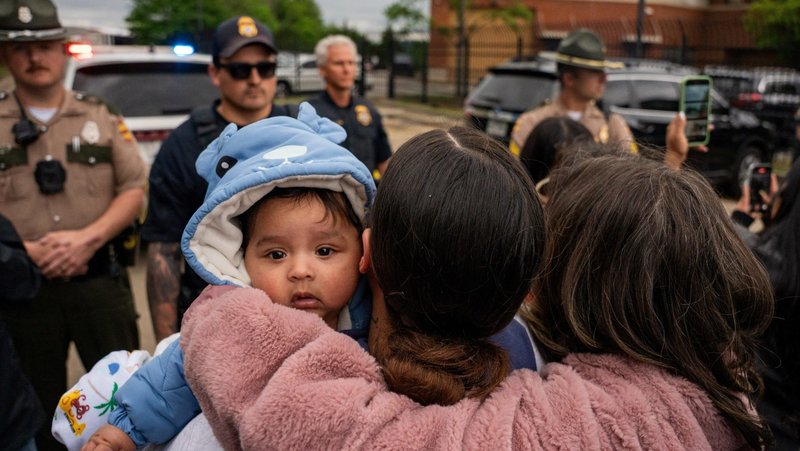 A mother holds her child as multiple immigrant rights groups gather at the Department of Homeland Security field office in Nashville, Tenn., to protest what they believe to be a multi-agency operation to detain-noncitizens overnight in Nashville, May 4, 2025. (OSV News photo/Seth Herald, Reuters)