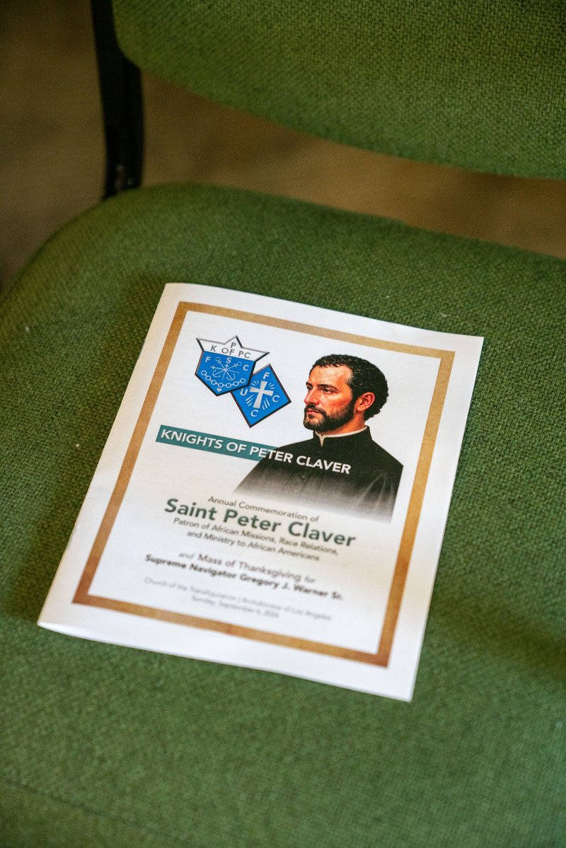 A program sits during the Sept. 6 Mass of Thanksgiving at Transfiguration Church for Greg Warner Sr.’s election as supreme navigator of the national Knights of Peter Claver. (John Rueda)
