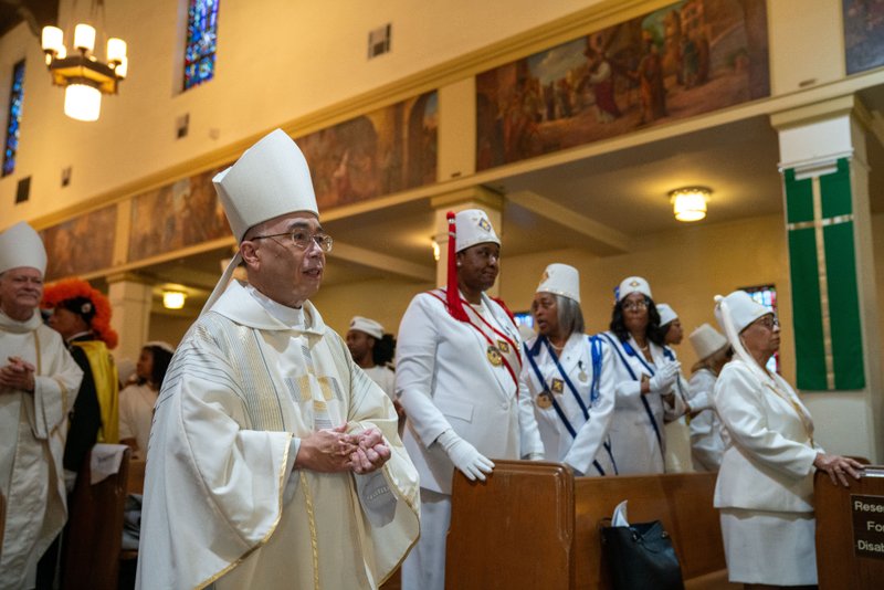 Auxiliary Bishop Brian Nunes processes in during the Sept. 6 Mass of Thanksgiving at Transfiguration Church for Greg Warner Sr.’s election as supreme navigator of the national Knights of Peter Claver. (John Rueda)