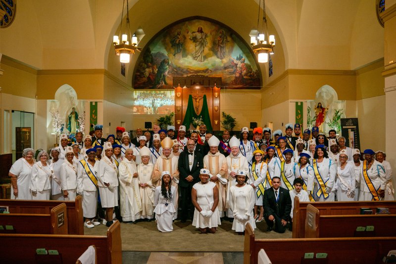 Local Knights and Ladies Auxiliary of Peter Claver pose with bishops and clergy after the Sept. 6 Mass of Thanksgiving at Transfiguration Church for Greg Warner Sr.’s election as supreme navigator of the national Knights of Peter Claver. (John Rueda)