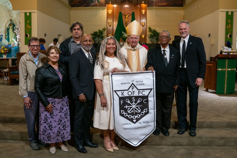 Archbishop José H. Gomez poses with members of Orange County's Knights of Peter Claver following the Sept. 6 Mass of Thanksgiving at Transfiguration Church for Greg Warner Sr.’s election as supreme navigator of the national Knights of Peter Claver. (John Rueda)