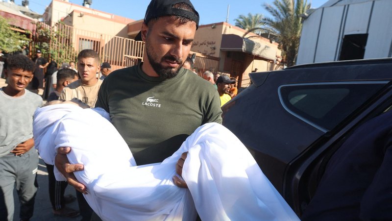 A man carries the body of of a 10-year-old Palestinian girl during her funeral in the southern Gaza Strip, Aug. 24, 2026. She was shot in the back while eating inside her family's tent and later died at Nasser Hospital in Khan Younis, according to medics and relatives. A network of Catholic priests in Africa has become the latest group to declare genocide in Gaza, as the United Nations reports continuing airstrikes, deaths and injuries, amid a shaky ceasefire in the area. (OSV News photo/Ramadan Abed, Reuters)