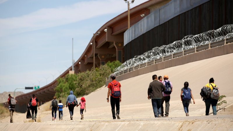 Migrants walk after crossing the Bravo River at the border line between Ciudad Juarez, Mexico, and El Paso in Texas, U.S., as seen from Ciudad Juarez, May 9, 2019. In a statement marking National Migration Week Sept. 21-27, Bishop Brendan J. Cahill, chairman of the U.S. bishops' urged U.S. officials and lawmakers to enact policy that upholds the "God-given human dignity" of migrants and prevents the separation of families. (OSV News photo/Jose Luis Gonzalez, Reuters)