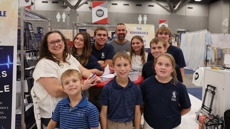 The Engstrom family pauses for a photo in the exhibition hall at the Dome at America’s Center in St. Louis Sept. 23, 2026. The healing of James Engstrom, who was born without a pulse on Sept. 16, 2010, and remained clinically dead for an hour before his heart began beating, led to a Church-approved miracle that helped advance the cause for Archbishop Fulton J. Sheen’s beatification. (OSV News photo/Margaret Murray)