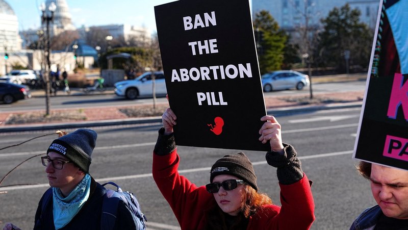 Demonstrators hold signs during a protest outside the U.S. Department of Health and Human Services in Washington Jan. 22, 2026, calling on President Donald Trump's administration to ban the abortion pill. In a Sept. 29, statement, Bishop Daniel E. Thomas of Toledo, Ohio, chairman of the U.S. bishops' pro-life committee, urged the faithful to mark Respect Life Month with prayer for an end to abortion and action to stop use of the abortion pill. (OSV News photo/Aaron Schwartz, Reuters)