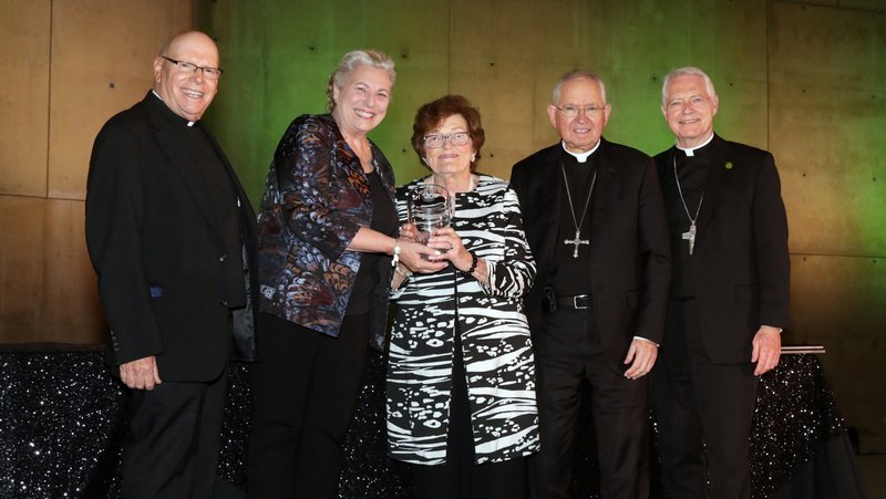 Marge Graf, general counsel for the archdiocese, accepts the Evangelii Gaudium Award from Heather Banis and Archbishop José H. Gomez Sept. 19. Also pictured are Bishop Matthew Elshoff (right), who served as the event’s master of ceremonies; and Father Leon Hutton, rector of St. John’s Seminary in Camarillo. (Belle N’ Beau Photography)