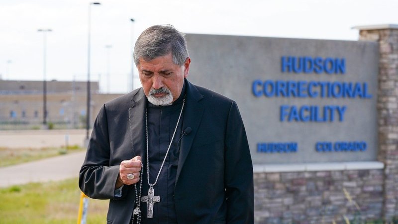 Denver Auxiliary Bishop Jorge Rodríguez prays the rosary July 10, 2026, outside a facility that is expected to be used as an ICE Detention Center in Hudson, Colo. He was joined by local Catholics and members of a Vatican delegation for human rights that was visiting the U.S. (OSV News photo/Joe Donelson, Denver Catholic)