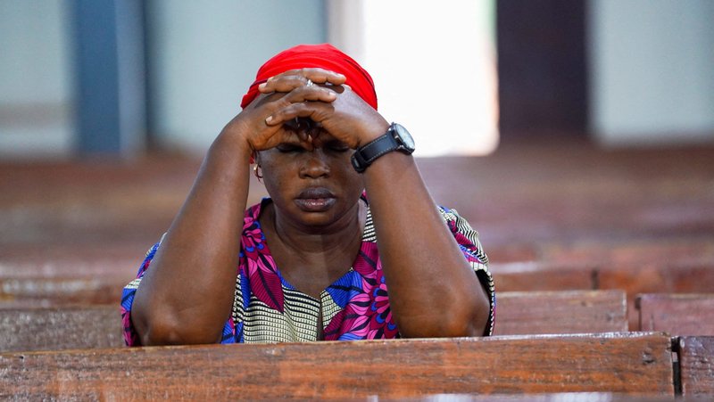 A woman prays during evening Mass at St. Michael Cathedral in Minna, Nigeria, Dec. 4, 2025. Catholic leaders in the Diocese of Otukpo, in Nigeria's Benue state, appealed for prayers following the Oct. 13, 2026, kidnapping of Father John Inalegwu Otache, pastor of St. Margaret Parish in Ajegbe–Awume. (OSV News photo/Marvellous Durowaiye, Reuters)