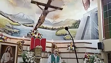 A large wooden crucifix is seen falling in this screenshot from video as Redemptorist Father Patricio Alfredo Sánchez Molinari celebrates Mass Oct. 17, 2026, at Our Lady of Perpetual Help Church in Guayaquil, Ecuador. The crucifix struck Father Sánchez directly on the head, killing him almost immediately. (OSV News/Church of Perpetual Relief in Guayaquil livestream video)