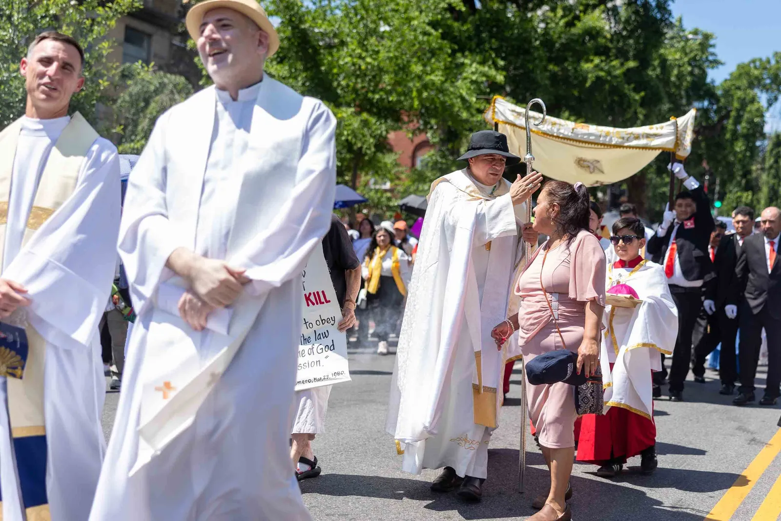 Auxiliary Bishop Evelio Menjivar-Ayala blesses a woman during a Corpus Christi procession held in solidarity with immigrants June 7 in Washington. The procession traveled from the Shrine of the Sacred Heart to the Cathedral of St. Matthew the Apostle. (Catholic Standard photo by Mihoko Owada)