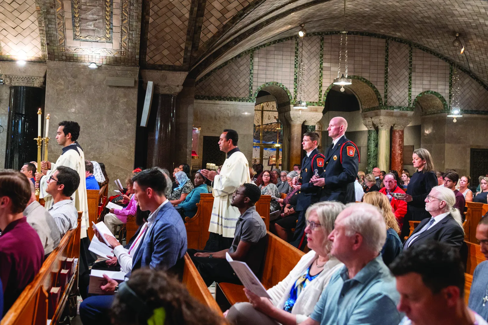 Members of the Arlington County Fire Department Color Guard in Virginia and a representative of the Archdiocese for the Military Services, bring up the offertory gifts during a Sept. 11, 2026, Mass at the Basilica of the National Shrine of the Immaculate Conception in Washington commemorating the 25th anniversary of Sept. 11, 2001, terrorist attacks. (OSV News photo/Mihoko Owada)