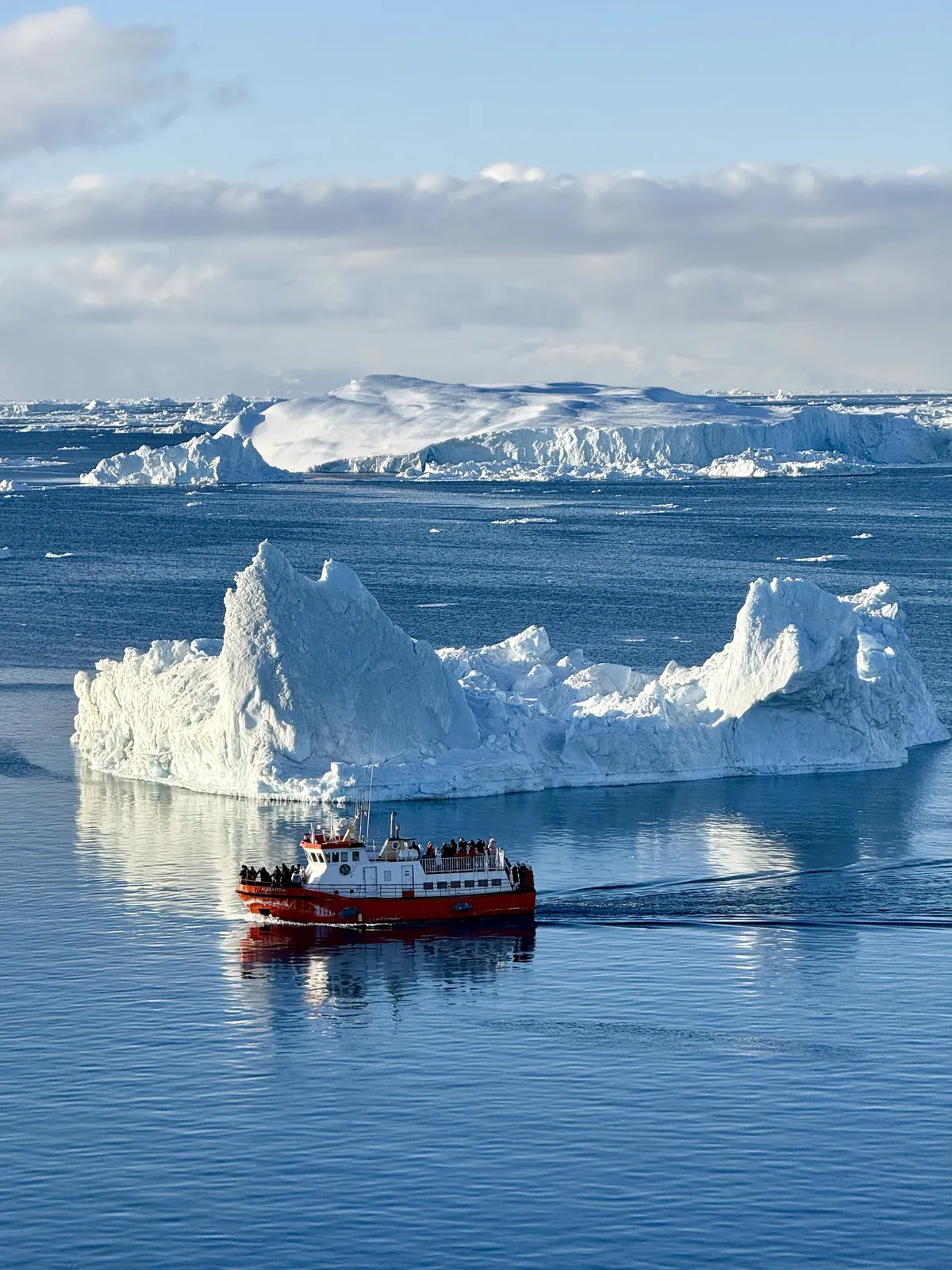 A boat navigates around a portion of an iceberg near Nuuk, Greenland, in this undated photo provided by Franciscan Father Tomaz Majcen, the only Catholic parish priest serving in Greenland. (OSV News photo/Father Tomaz Majcen)