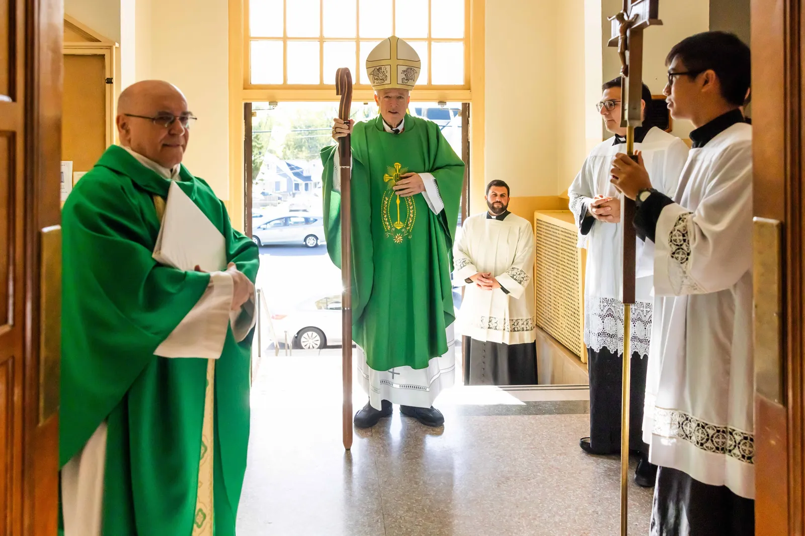 Washington Cardinal Robert W. McElroy prepares to process into St. James Church in Mount Rainier, Maryland, for a Mass on Oct. 25, 2026 marking the church’s 100th anniversary. At left is Father Pablo Bonello, a priest of the Institute of the Incarnate Word who serves as St. James’ pastor. Standing in the background at right is Father Thomas Robertson, the cardinal’s priest secretary. (Catholic Standard photo by Andrew Biraj)