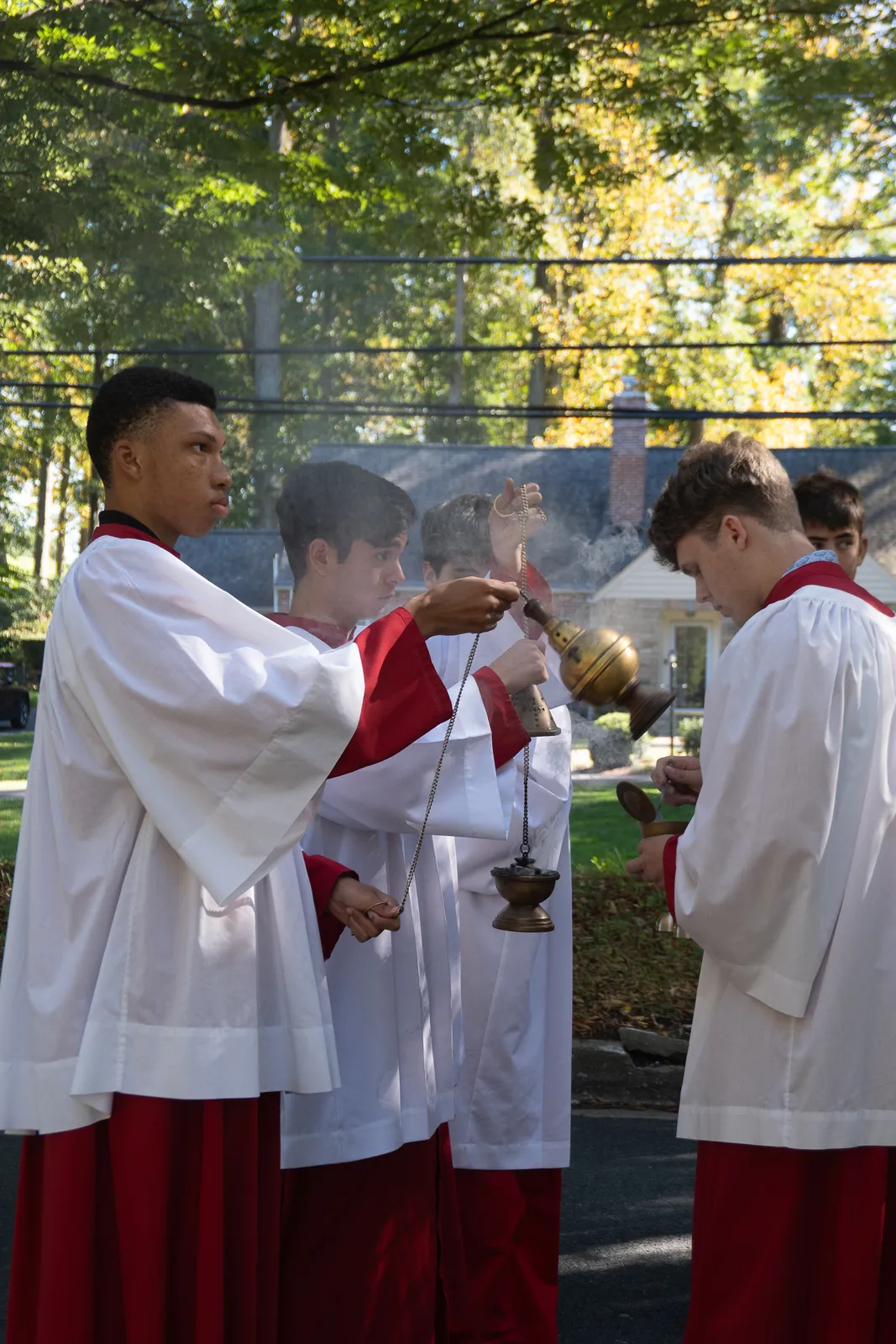 Altar servers help lead an outdoor Eucharistic procession marking the 60th anniversary of St. Patrick Parish in Rockville, Maryland, on Oct. 18, 2026. Girls dropped rose petals on the road as the procession wound from the Manor Country Club back to St. Patrick Church. (Catholic Standard photos by Margaret Ardillo)