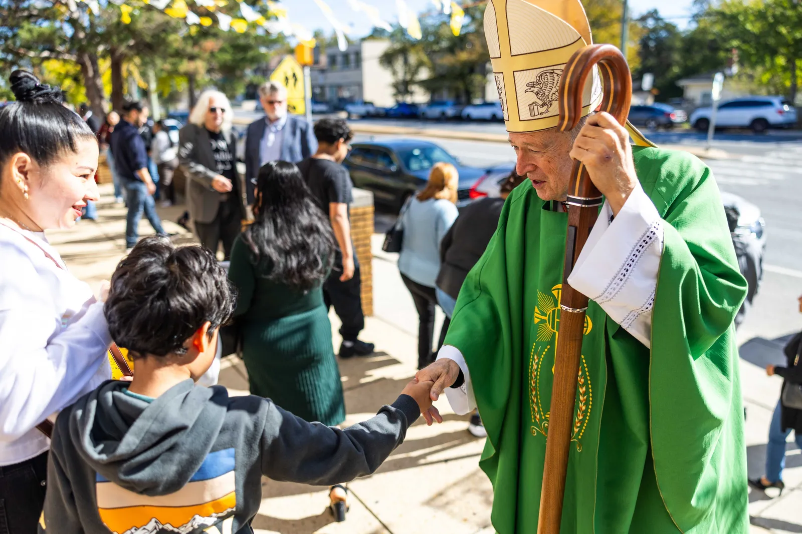 Washington Cardinal Robert W. McElroy greets a family after celebrating a Mass on Oct. 25, 2026 marking the 100th anniversary of St. James Church in Mount Rainier, Maryland. (Catholic Standard photo by Andrew Biraj)
