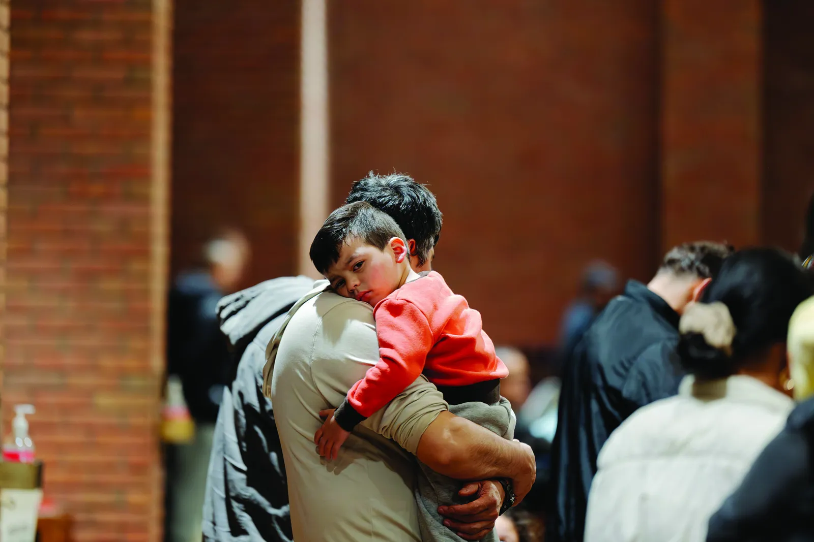 A father carries his sleepy toddler during a Stations of the Cross service at St. Camillus Catholic Church on March 20. (Catholic Standard photo by Nicole Olea)
