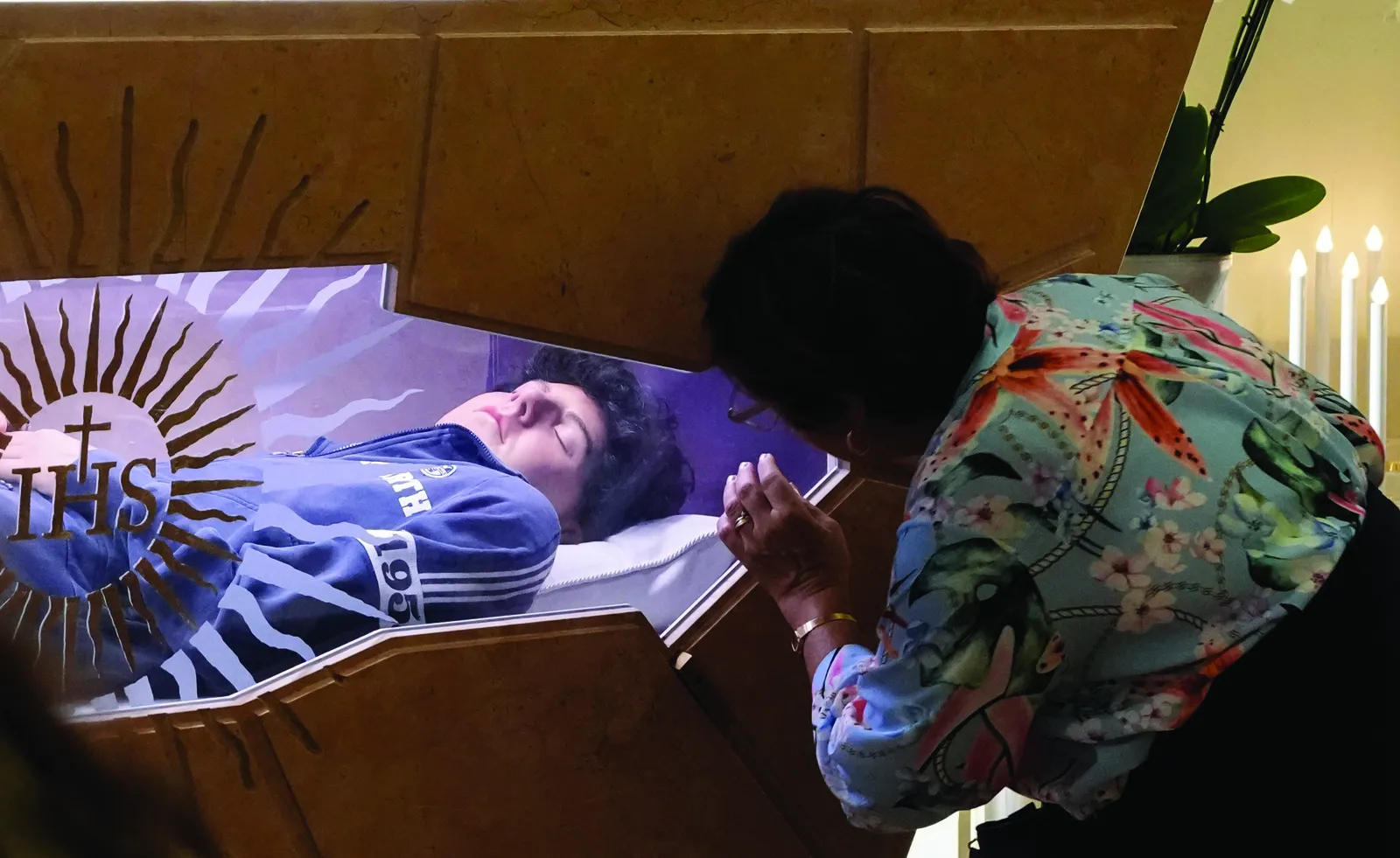 A woman prays at the tomb of Blessed Carlo Acutis in the Shrine of the Renunciation in Assisi, Italy, Aug. 21, 2025. Acutis, who died in 2006 at age 15, will be canonized Sept. 7 at the Vatican by Pope Leo XIV. (CNS photo/Lola Gomez)