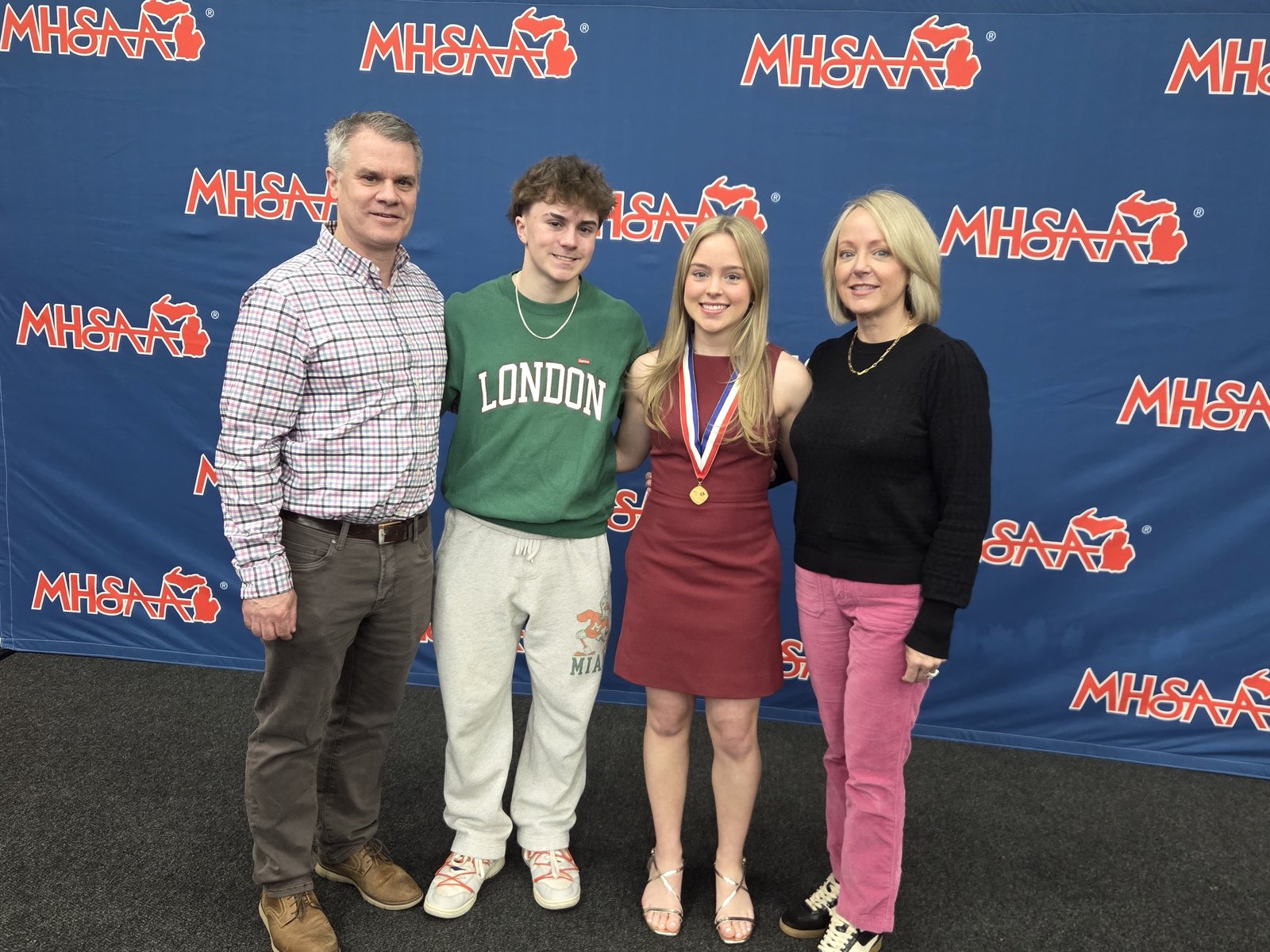 Madison Karakashian is accompanied by her father, Jim, her brother, Carson, and her mother, Heidi, at the Michigan High School Athletic Association’s Scholar Athlete Award Scholarship banquet at Michigan State University. (Photo by Wright Wilson | Special to Detroit Catholic)