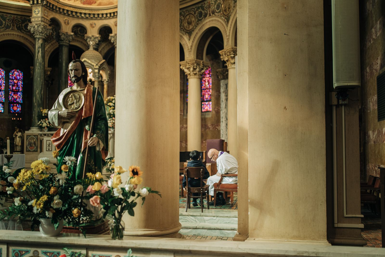 A priest hears confessions at Most Holy Redeemer Parish in southwest Detroit in this file photo. During the Jubilee of Hope, pilgrims can receive a plenary indulgence by visiting pilgrimage sites in the Archdiocese of Detroit after having been to confession, prayed for the intentions of the Holy Father, and receiving the Eucharist. (Detroit Catholic file photo)