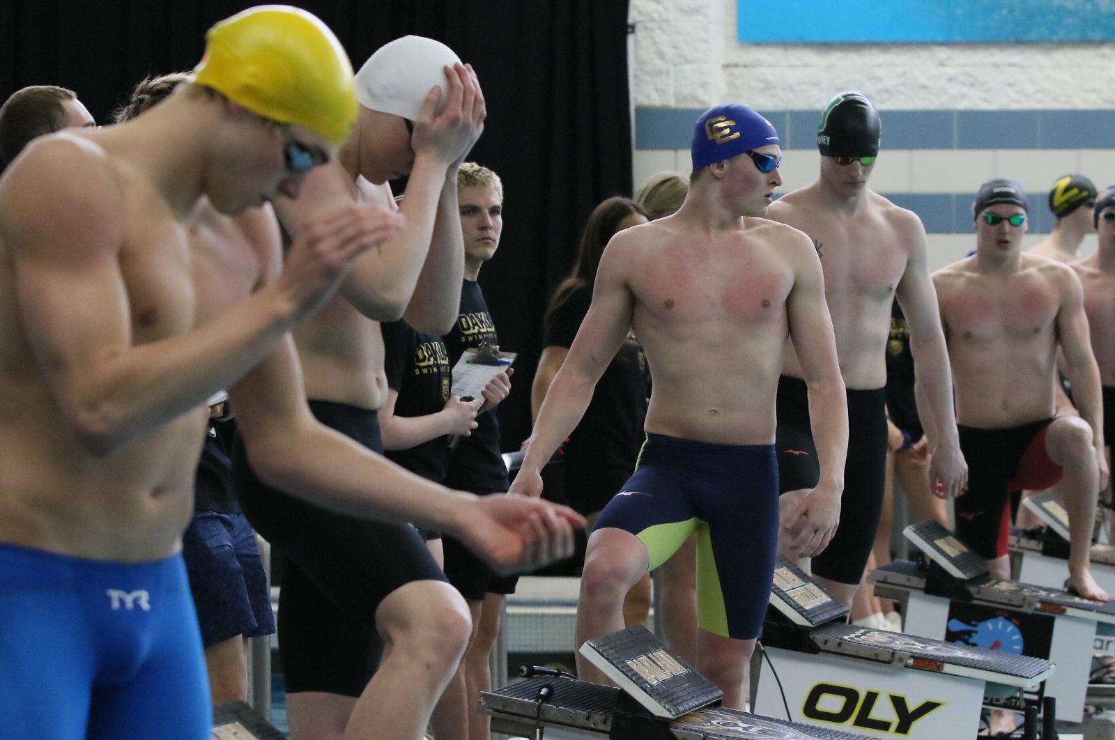 Detroit Catholic Central’s Camren Turowski (in blue cap) psyches himself up for his championship-heat 50 freestyle sprint race at the Division 1 state finals at Oakland University. (Photo by MHSAA/High School Sports Scene)