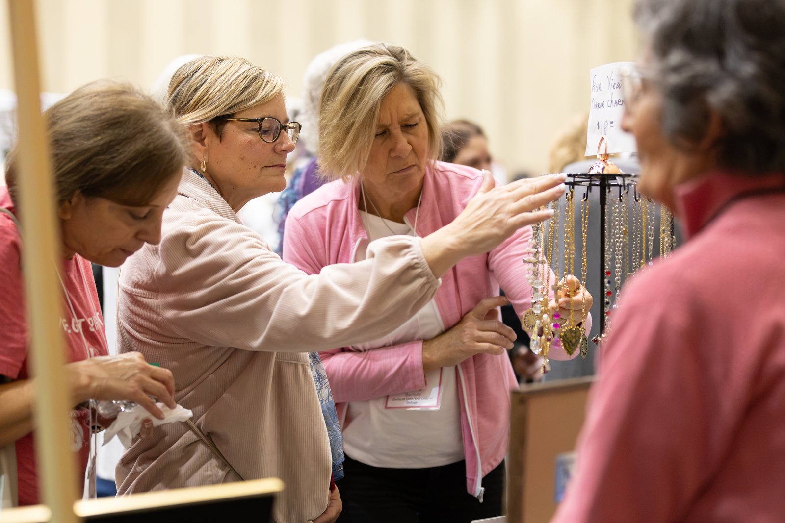 Conference attendees check out rosaries on display in the vendor section of the conference.