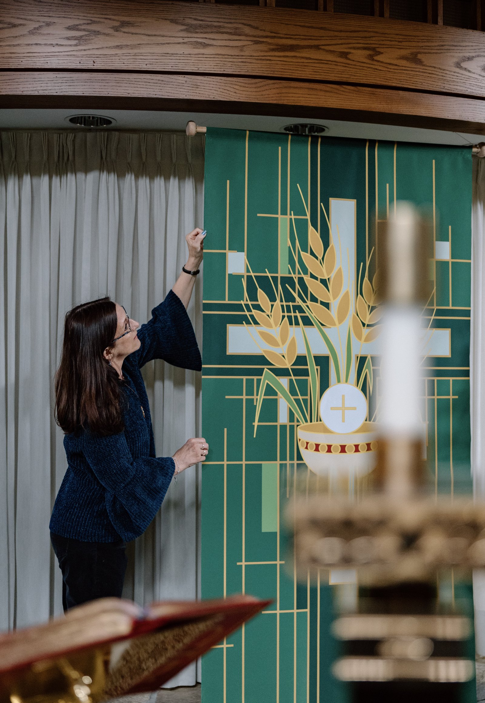 Theresa Wilson helps prepare the sanctuary for Mass at St. Rene Goupil Parish in Sterling Heights, one of many activities and outreach efforts Wilson arranges for the parish.