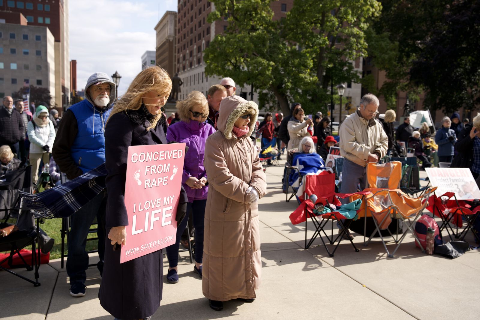 Rebecca Kiessling, left, an international pro-life speaker and attorney who was conceived in rape and often tells her personal story, stands with pro-life marchers on the steps of Michigan's capitol building in Lansing in October 2022.