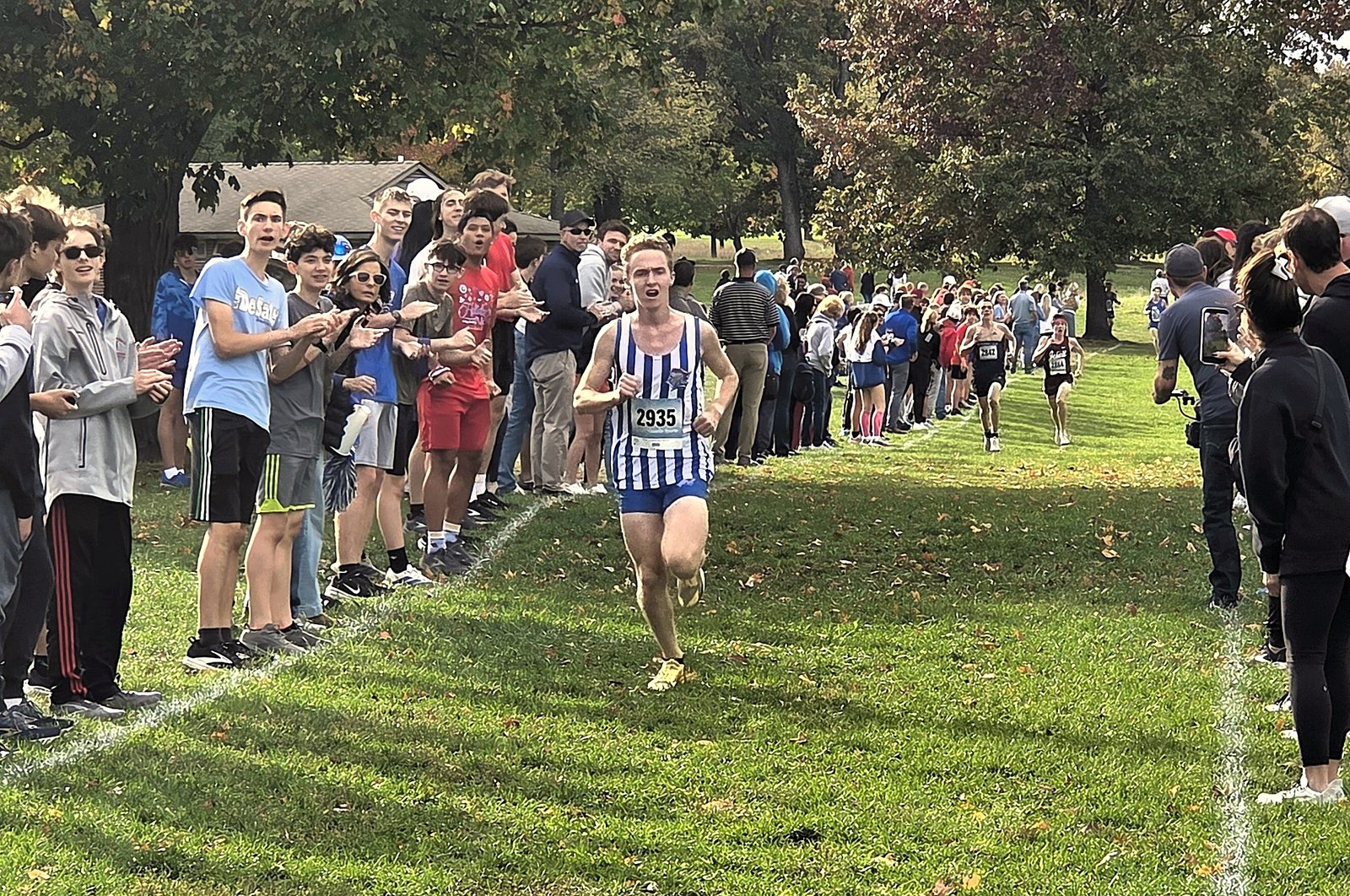 Toledo St. Francis’ Brennan Higgins maintains a five-second lead over the nearest competitors running down the home stretch of the 5-kilometer course at Kensington Metropark.