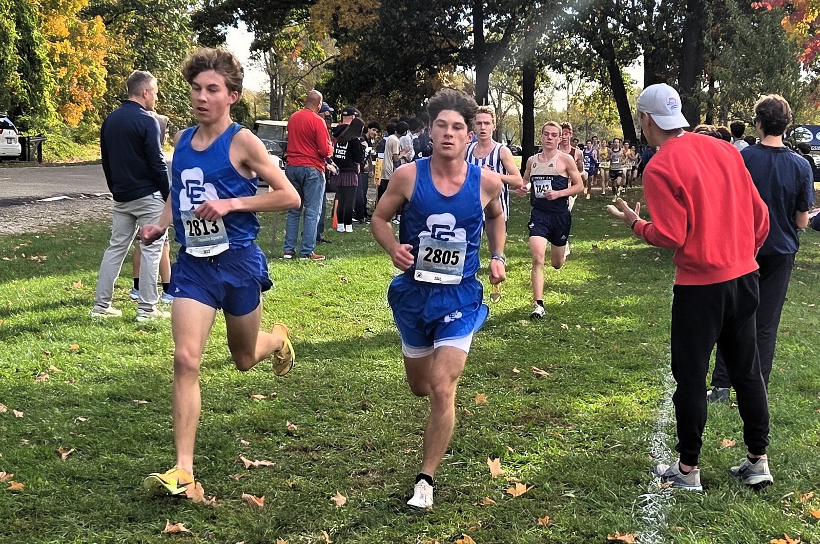 Detroit Catholic Central’s Luke Kramer and Brady Glon pass the one-mile mark in the lead of the Bishop Division boys race. The duo each posted a top-five finish, helping the Shamrocks into the runner-up team slot.