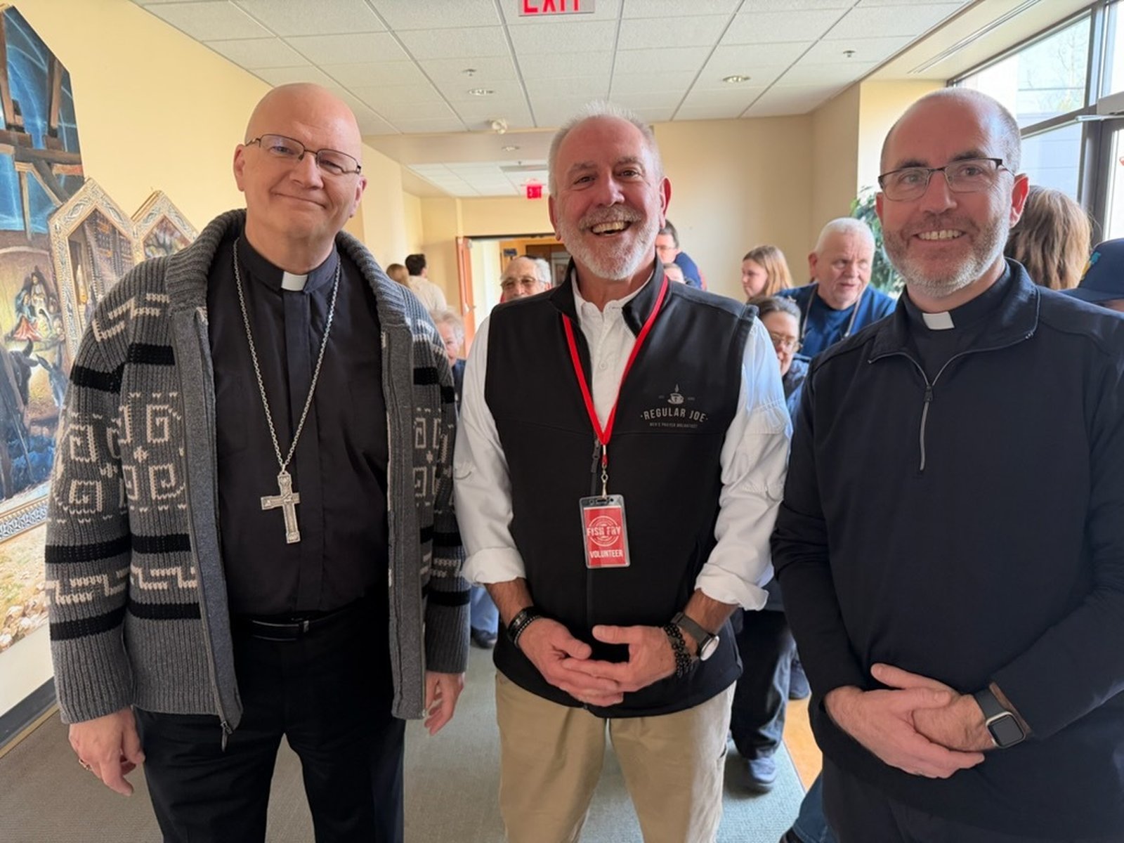 Archbishop Edward J. Weisenburger, left, is pictured with Fr. Timothy Birney, right, vicar general and moderator of the curia for the Archdiocese of Detroit, along with Fr. Birney's brother, Mike Birney, who led Our Lady of Good Counsel's fish fry.