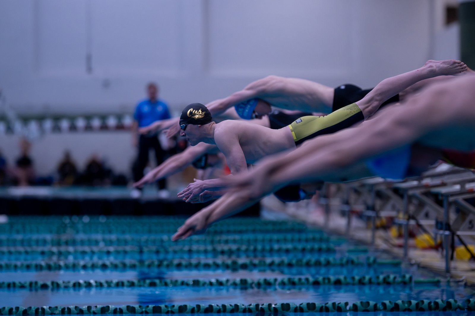 University of Detroit Jesuit freshman Miles Lobley takes off from the starting blocks in the consolation final of the 200 freestyle. He also contributed to the Cubs’ winning 400 free relay team. (Photo by MHSAA/High School Sports Scene)