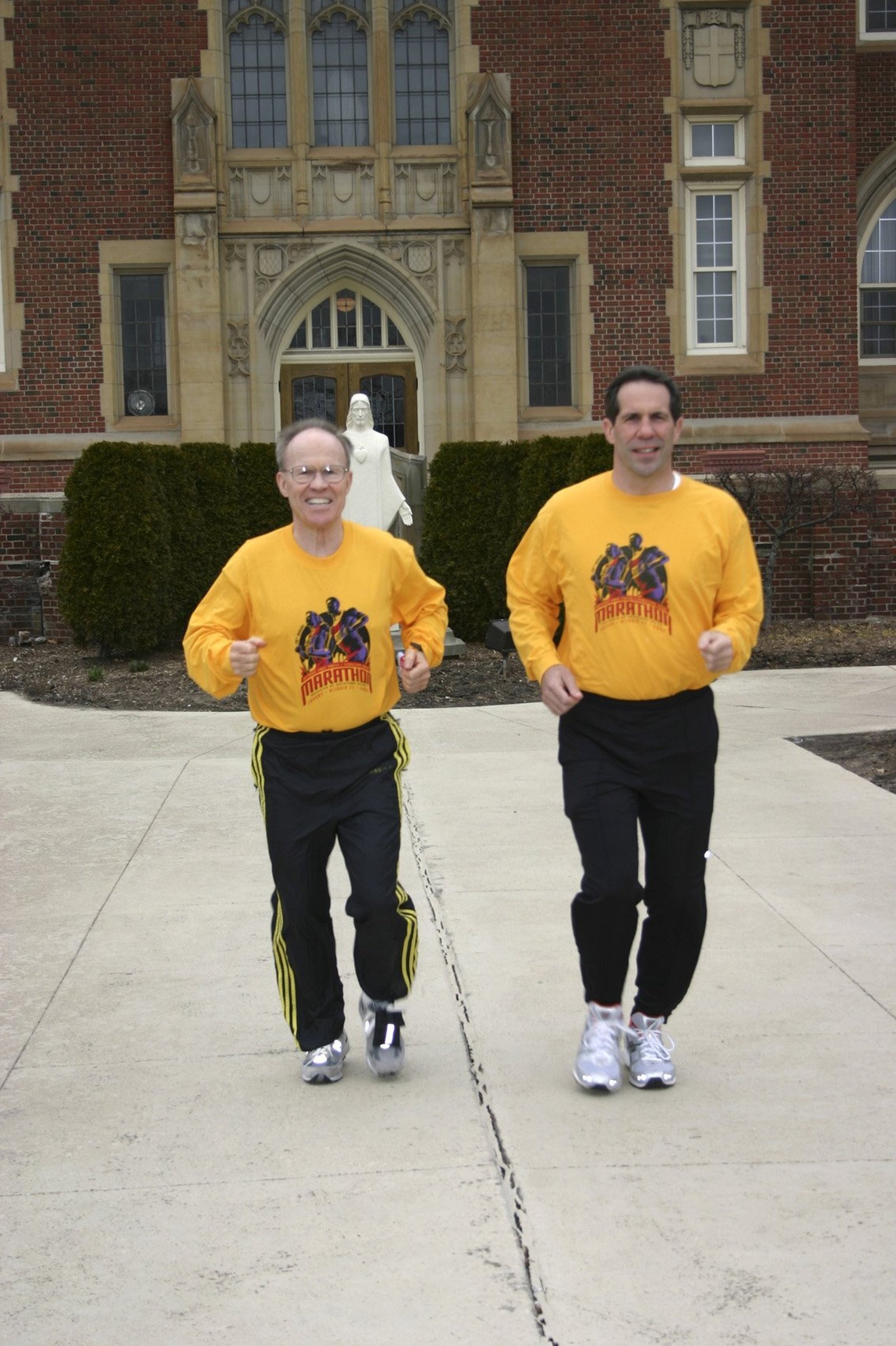 Fr. Richard Cassidy and Archbishop Byrnes jog on the grounds of Sacred Heart Major Seminary in late March 2006. The two qualified for the 2006 Boston Marathon, but because it was the day after Easter, they asked to run it the following year, instead. (Kristin Lukowski | The Michigan Catholic)