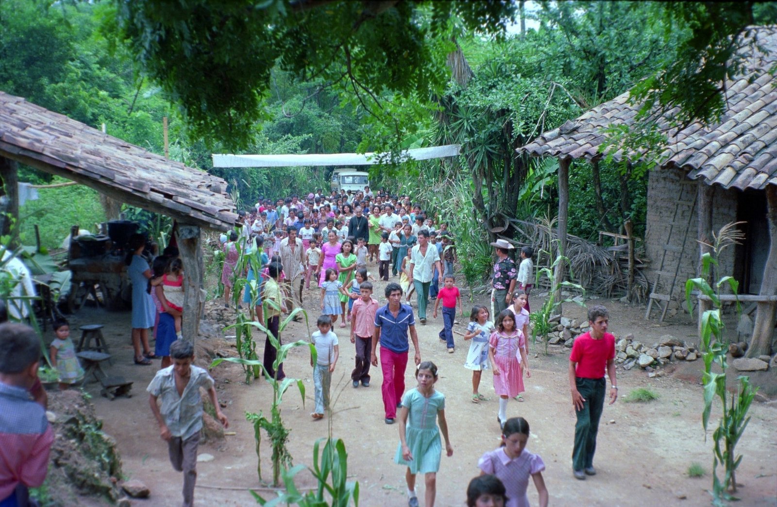 A crowd of people from San Antonio Los Ranchos in Chalatenango, El Salvador, walk with Archbishop Oscar Romero as he arrives to celebrate Mass in 1979. The archbishop was detained and interrogated by soldiers for 20 minutes before being allowed to continue his pastoral visit. Fearing violence, he asked that the Mass be celebrated outdoors. (CNS photo/Octavio Duran)