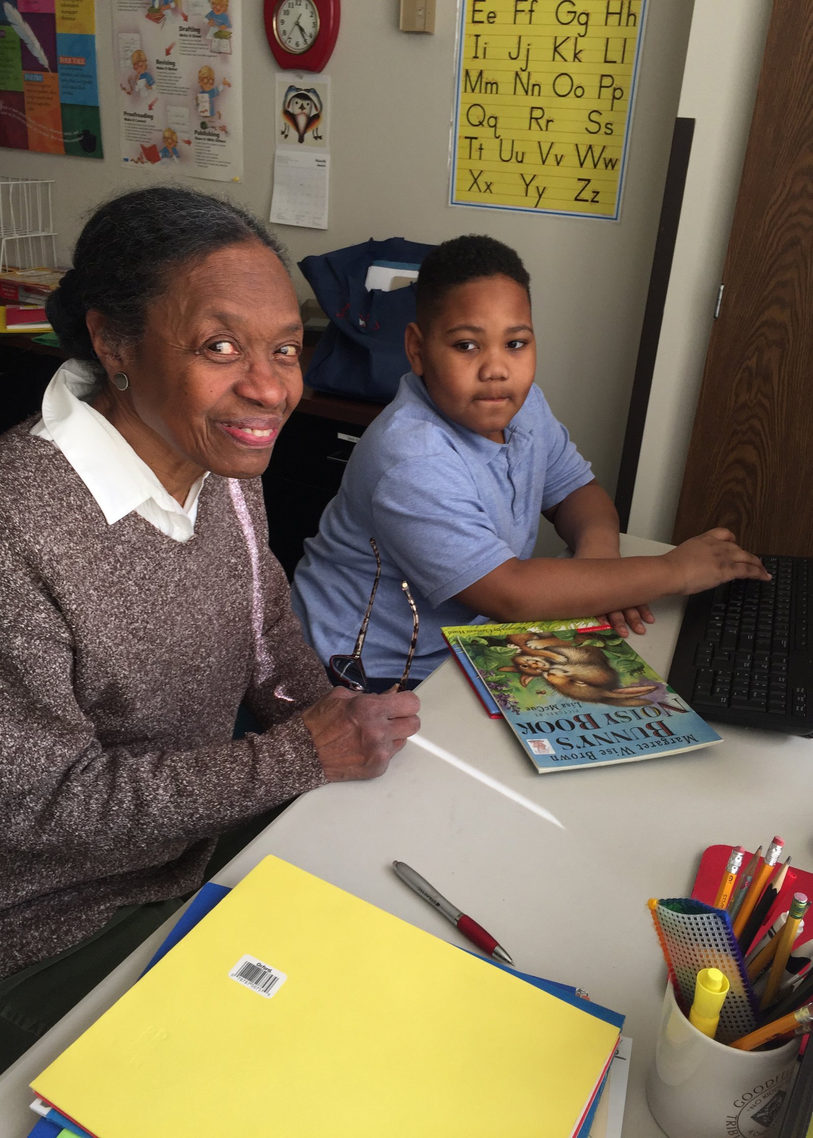 A volunteer tutor sits down with a student during a session at the Epiphany Education Center in Detroit. The Immaculate Heart of Mary (IHM) Sisters co-founded the Epiphany Education Center with the Adrian Dominicans in 2005.
