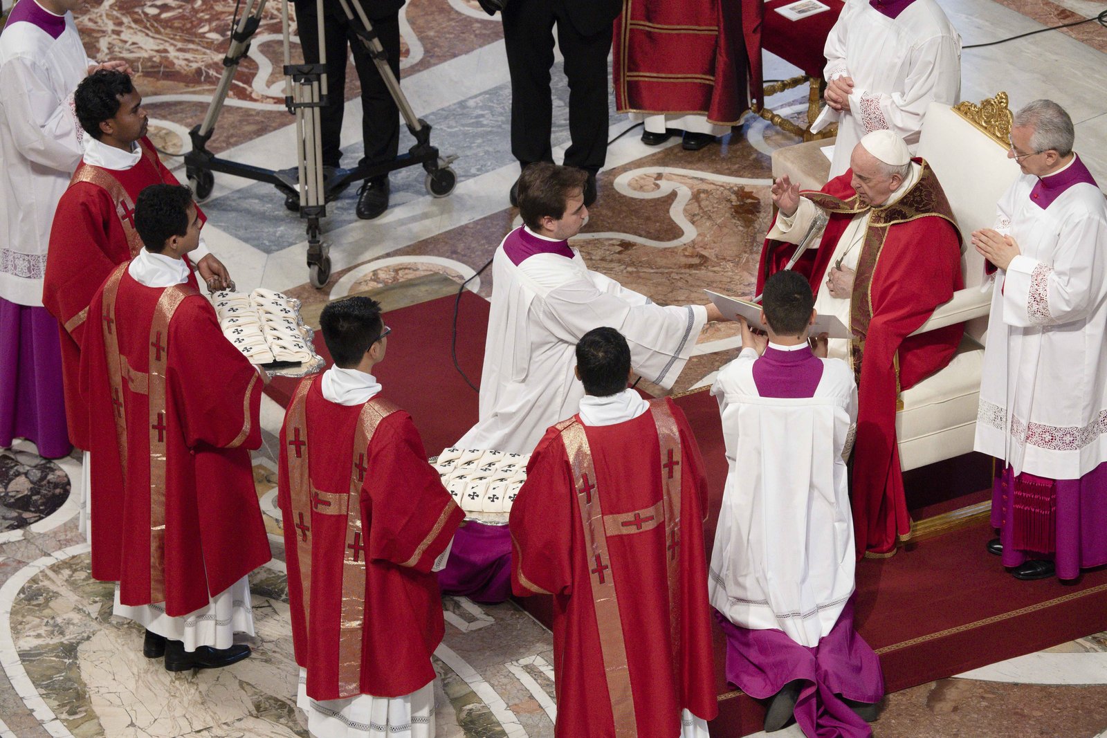 Pope Francis blesses palliums that deacons hold on trays during Mass at St. Peter's Basilica in Rome on June 29, 2022. This year, Pope Leo XIV will return to a tradition begun by St. John Paul II in 1983 by personally placing a pallium around the shoulders of recently named archbishops. (CNS photo/Vatican Media)