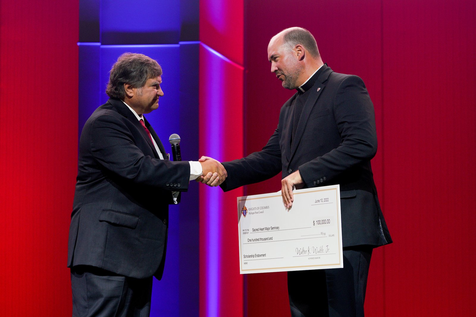 Fr. Stephen Burr, rector and president of Sacred Heart Major Seminary, accepts a check for $100,000 from the Michigan Knights of Columbus to benefit the seminary's education and formation of the next generation of priests.