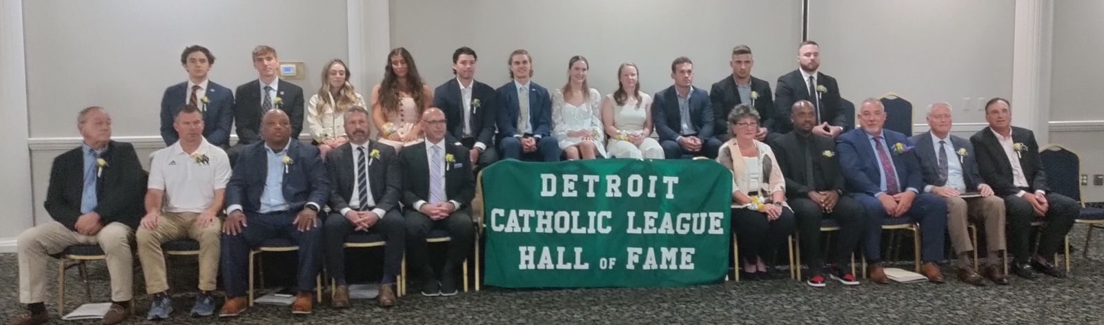The newest inductees into the Catholic League Hall of Fame: seated, l-r: Jim DeJaeger, Rick DeSana, Carl Brock, Jeff Garvin, Dave Wilson, Sr. Lenore Pochelski, Kevin Glenn, Ken Butler, Pat Donnelly, Dennis Janer. Standing, l-r: Liam McDonnell, Jonah Venos, Gabrielle Green, Ella Loussia, Brennan Kamish, Paul Manuszak, Elena Welker, Melina Livingston, Ryan Pierson,  Isaac Darkangelo, Drew Beesley. (Photo by Don Horkey | Special to Detroit Catholic)