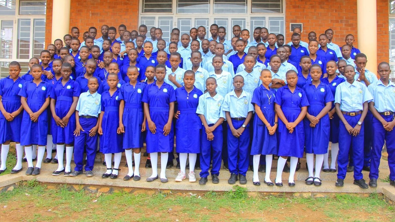 Students pose for a class photo at John Paul Secondary School in Chelekura, Uganda. The school's remarkable growth since it was founded in 2005 had led it to become one of the top schools in Uganda, today educating more than 800 students each year.
