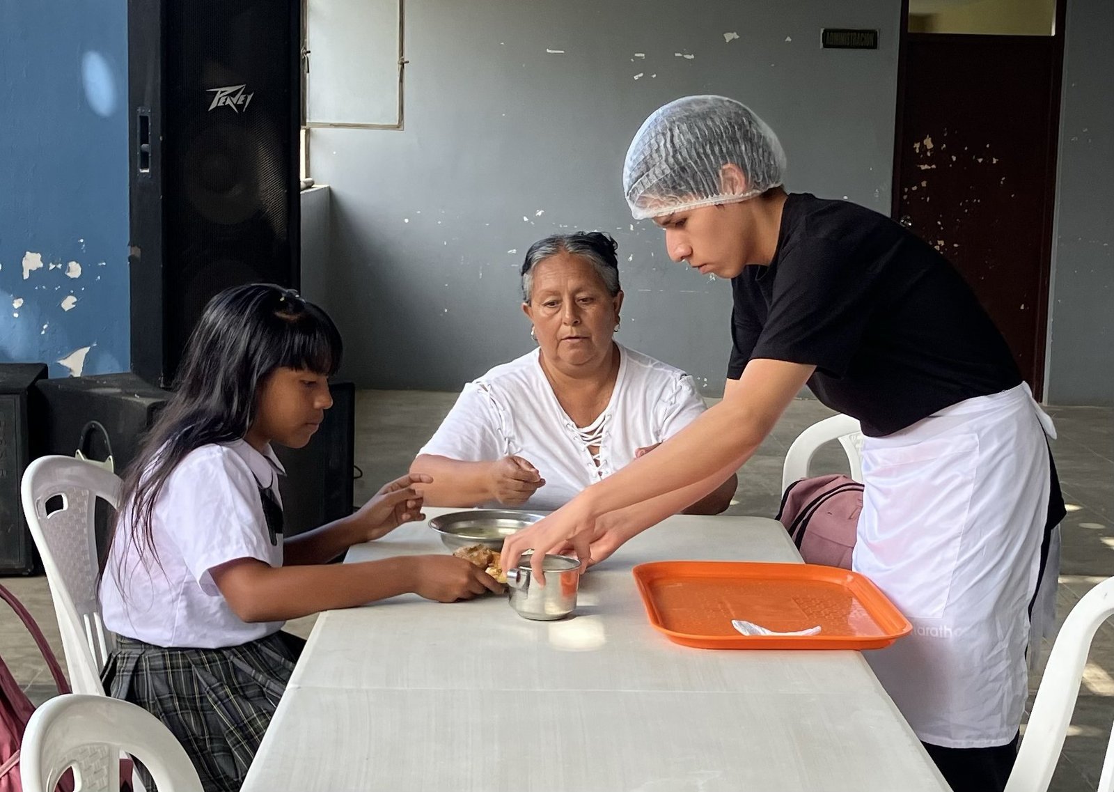 A member of the youth group at St. Martin of Tours Parish in Reque, Peru, serves lunch at a parish soup kitchen May 13, 2025. Parishes in the Diocese of Chiclayo, Peru, where Pope Leo XIV, was bishop for eight years, have emphasized youth ministries and involving young people in church life. (OSV News photo/David Agren)