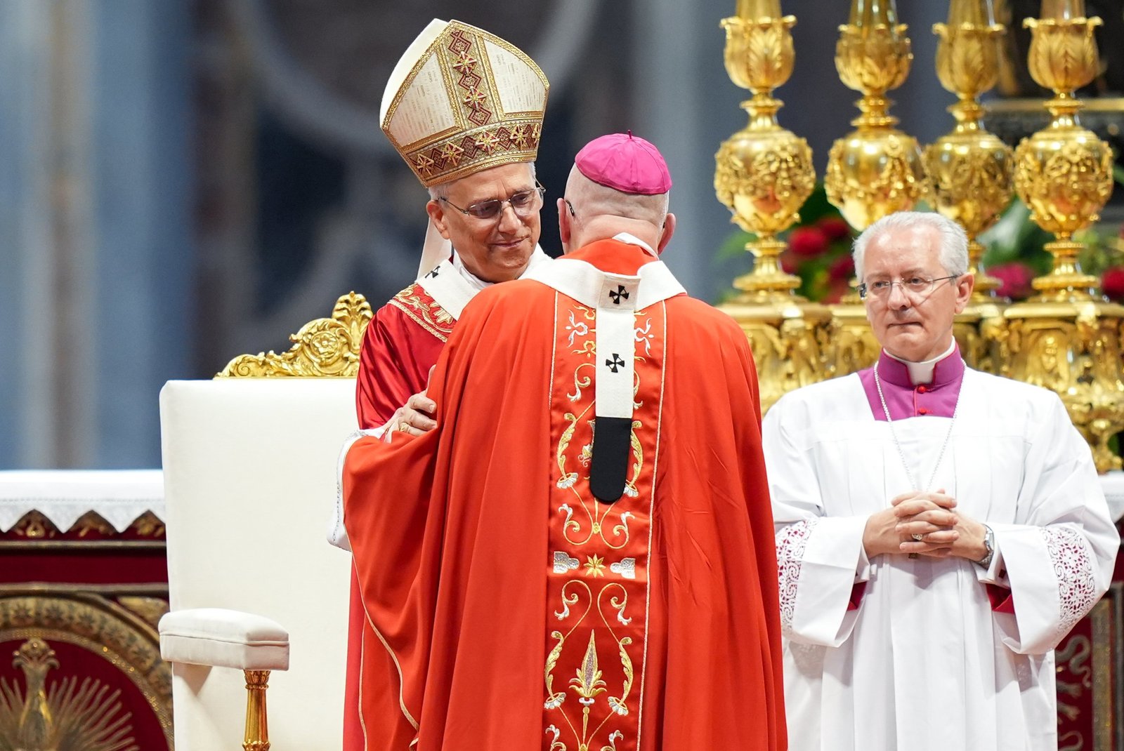 Pope Leo XIV smiles after presenting the pallium to Archbishop Edward J. Weisenburger during Mass in St. Peter’s Basilica at the Vatican. Archbishop Weisenburger said he assured the pope of the prayers of the people of the Archdiocese of Detroit, saying Detroiters have "much affection" for the Holy Father, whose diaconal ordination took place in the archdiocese. (CNS photo/Lola Gomez)